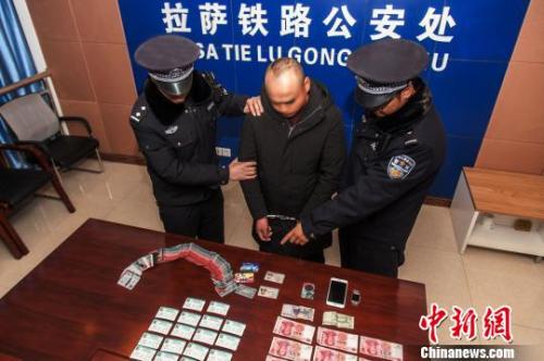 資料圖：一犯罪嫌疑人對拉薩鐵路警方查獲的火車票進行指認。　胡傳鑫 攝